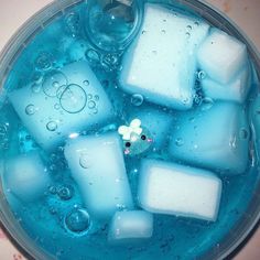 ice cubes and water in a bowl with bubbles