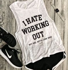 a white tank top that says i hate working out but got a look good