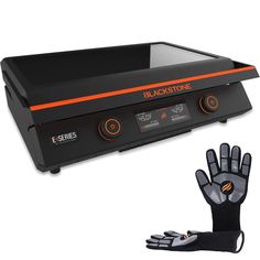 an electric heater with gloves on it and a black glove next to the oven