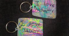 two keychains with the words i love mommy and i love daddy written on them