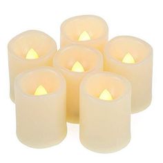 six lit candles are arranged in rows on a white background