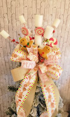 a decorated christmas tree with candles and candy canes