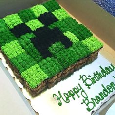 a square cake with green and black frosting