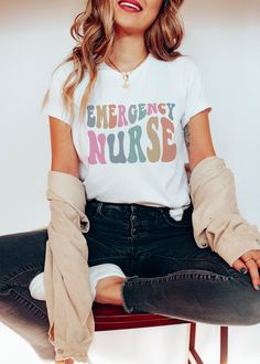 "Retro Groovy Emergency Nurse Shirt ER Nurse Graphic Tee Tshirt Registered Nurse RN Shirt Nursing School Graduate Shirt LPN Nursing Gift Tee  Women: For trendy oversized t-shirt dress style, size up 1-3 sizes (depending on how oversized you prefer) If you prefer a regular fit, typically we suggest ordering your normal size or one size down if you like it more form fitted. This listing is for ONE (1) adult unisex t-shirt. ❤ High quality prints that will last ❤ Comfortable & flattering fit (fits true to size) ❤ Soft and Light weight, with just the right amount of Stretch ❤ Machine washable & dryer safe SHIRT DESIGN ❤ All of our shirts are created with the latest in garment printing technology. All the inks used are water based and eco-friendly. This helps to create a softer feel than traditi Animal Rescue Shirt, Nurse Graphic, Emergency Nurse, Saving Animals, Lpn Nursing, Future Doctor, Oversized T Shirt Dress, Er Nurse, Graduation Shirts