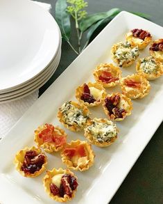 small appetizers are arranged on a white plate