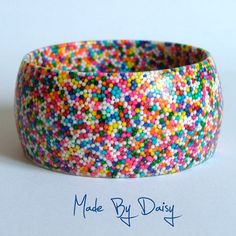 a close up of a colorful bracelet with sprinkles on the inside of it