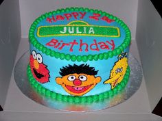 a birthday cake with sesame street characters on it