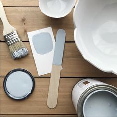 the paint is being used to decorate dishes and other things on the wooden floor with it's brush