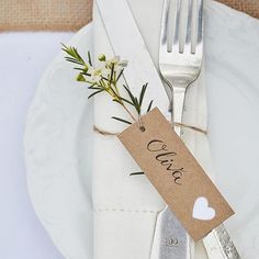 a white plate topped with a fork and knife next to a tag that says love