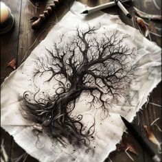 a piece of paper with a drawing of a tree on it next to scissors and other items