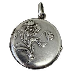 THIS IS A GORGEOUS FRENCH ART NOUVEAU LOCKET PENDANT IN STERLING SILVER WITH A BEAUTIFUL REPOUSSE DESIGN OF A FLOWER WHICH MAY BE A POPPY WITH GORGEOUS LEAVES. This is just a stunning sterling silver poppy flower motif locket with exquisite Art Nouveau design. The beautiful locket has a wonderfully designed poppy flower on the front. The reverse of the locket is unadorned. The locket opens to reveal places for a photo. The original photo cover is intact. The locket is hallmarked with the French Art Nouveau Locket, Stile Art, Design Art Nouveau, Photo Cover, Bijoux Art Nouveau, French Art Nouveau, Vintage Fans, Art Nouveau Design, Flower Motif