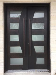 a black double door with two sidelights and glass panels on the outside of it