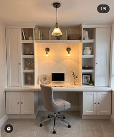 a home office with built - in shelving and desk