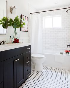 a bathroom with black and white tile flooring