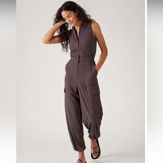 Review Summary Customers Are Raving About The Comfort And Versatility Of The Brooklyn Utility Jumpsuit. They Love The Lightweight Fabric And The Ability To Dress It Up Or Down. The Adjustable Legs And Numerous Pockets Are Also A Hit. Overall, Customers Highly Recommend This Jumpsuit For Its Flattering Fit And Stylish Design. Product Details For: Commuting, Work, And Travel Feel: Featherweight Stretch Is Made With Recycled Polyester And Feels Light As Air Fave: Side Cargo Pockets Hold Your Essent Utility Romper, Wrinkled Clothes, Utility Jumpsuit, Work And Travel, Long Romper, Printed Rompers, Athleta Pants, Black Romper, Wide Leg Jumpsuit