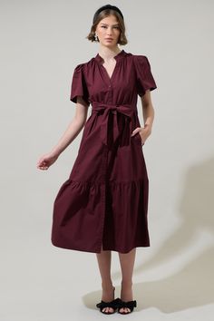 The Beatrice Button Down Poplin Midi Dress is the best pick of the season and we're obsessed! Adorned with short puff sleeves and a belt tie around the waist. It has a button-down placket all along the front leading to a bottom ruffle tier. Wear it with any shoes and bag to create a stylish ootd! - Button down- Bubble sleeves- Pockets- Breathable fabric- Comes in 2 colorsSize + Fit - Model is 5'8" and wearing size XS- Measurements taken from size S - Chest: 19"- Length: 48 1/4" Fabric Self: 100% Short Sleeve Belted Dress For Work, Short Sleeve Belted Dress For Daywear, Summer Short Sleeve Belted Dress With Buttons, Summer Belted Dress With Buttons And Short Sleeves, Short Sleeve Shirt Dress With Tie Fastening For Work, Short Sleeve Midi Dress With Tie Waist, Midi Dress With Tie Waist And Short Sleeves, Daywear Short Sleeve Belted Dress, Chic Short Sleeve Belted Dress With Button Closure