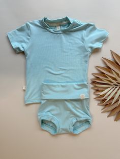 Upgrade your baby's wardrobe with our premium bamboo outfits, featuring elastic-free bloomers with a fold over-waistband and leg cuffs to provide maximum comfort around baby's belly and thighs, paired perfectly with our bamboo relaxed fit t-shirt. This set is made from high-quality bamboo that is incredibly soft with the perfect amount of stretch, offering exceptional comfort, breathability, and eco-friendliness. 95% Bamboo Viscose, 5% Spandex Relaxed Fit Tee Great for sensitive skin, breathable Newborn Fashion, Grandpa Style, Blue Luxury, Baby Bamboo, Mom Of 3, Newborn Gown, Baby Belly, Caribbean Blue, Tee Set