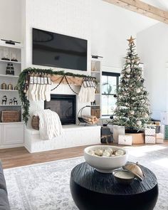 a living room with a christmas tree and fireplace