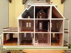 a doll house with all the furniture and accessories in it's display case on top of a table