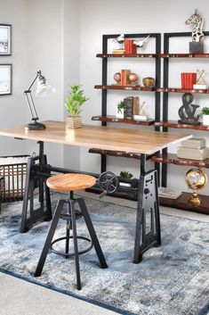 a desk with two stools in front of it and bookshelves on the wall