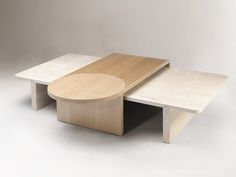 a table with a wooden bench on top of it next to a white wall and floor