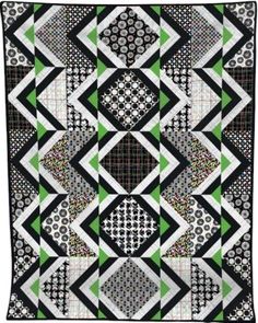 a black and white quilt with green accents