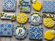 decorated cookies with lemons and blue tiles on a wooden surface, including the number seventy