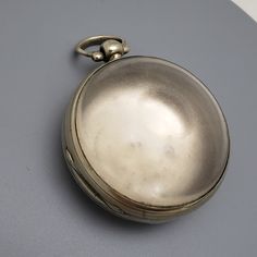 Large Pocket Watch Case Probably silver but it is unmarked. Most likely would have been for a fusee verge watch winding from the back and setting at the front.  51 mm outside diameter not including the crown/pendant. Serial # 2904 and 22 marked inside.  Very deep, 13.3 mm depth(approx). Good hinges, snaps closed firmly.  High dome bulls eye glass crystal has profuse scratching. Bow swings freely. Silver Round Pocket Watch With Locket, Silver Victorian Pocket Watch, Antique Silver Pocket Watch With Locket, Victorian Round Pocket Watch Collectible, Antique Silver Pocket Watch Collectible, Antique Round Pocket Watch With Stopwatch, Antique Pocket Watch With Stopwatch, Antique Silver Collectible Pocket Watch, Vintage Silver Pocket Watch With Round Pendant