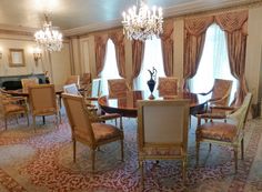 a formal dining room with chandelier and chairs in it's center table