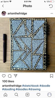 a notepad and pen sitting on top of a wooden table next to each other