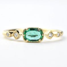 Four round-brilliant diamonds weighing a total of .05 carats One oval cut Emerald weighing .60 cts 14k yellow gold Finger size 7 1/4 * Imported  *This ring can be re-sized to sizes ranged 5-9 at no extra charge. If you would like to have this ring sized please send us a message.  Goldmakers Jewelry Mission Statement Go Oval Emerald Ring With Single Cut Diamonds, Oval Emerald Ring With Diamond Accents, Oval Emerald Ring With Single Cut Diamonds For Anniversary, Oval Rose Cut Diamond Rings For May Birthstone, Classic Oval Emerald Ring With Single Cut Diamonds, 14k Gold Diamond Ring With May Birthstone Accents, Oval Diamond Ring For May Birthstone, Oval Emerald Diamond Ring With Bezel Setting, Heirloom Diamond Ring With May Birthstone Accents