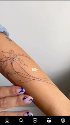 a woman's arm with a tattoo on it and the words lily written in cursive writing