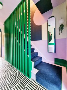 the stairs are painted in different shades of green, purple and white with geometric designs