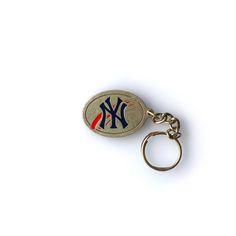 a new york yankees keychain is shown on a white background