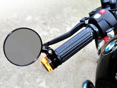 a close up view of the handlebars and mirrors on a motorbike