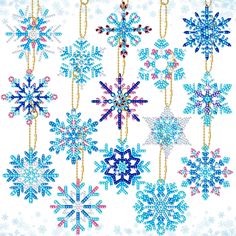 several snowflakes hanging from chains on a white background with snow flakes all around