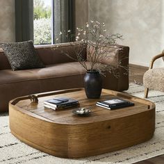 a living room with a couch, coffee table and two cell phones on top of it