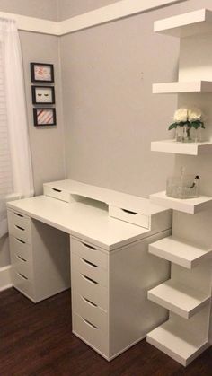 a white desk with shelves and drawers in a room that has hardwood floors, a window, and a door