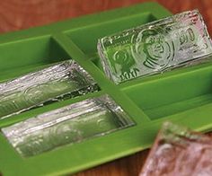 three green trays filled with different types of glass items