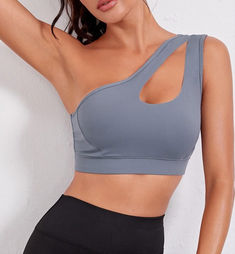 FlexEase Single Shoulder Sports Bra, a perfect blend of style and support designed for women who prioritize both fashion and functionality in their fitness wardrobe. This sports bra boasts a sleek and modern design, featuring a single shoulder strap that not only adds a touch of flair but also ensures maximum flexibility during workouts. The stylish silhouette is complemented by the strategic construction that provides excellent support, making it an ideal choice for various fitness activities. Shoulder Yoga, Women Sports, Top Crop, Gym Shirts, Bra Straps