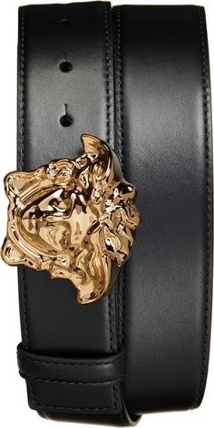 a black leather belt with a gold metal lion buckle on the front and side of it