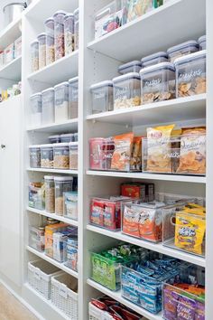 an organized pantry filled with lots of food and containers on the shelves, labeled with labels