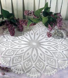 a white doily sitting on top of a wooden table