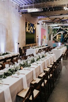 the tables are set with white linens and greenery