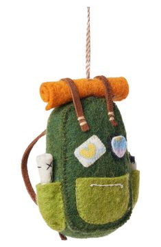 a green backpack ornament hanging from a rope