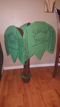 a tree made out of green paper with writing on it