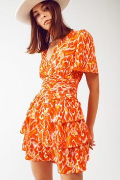 Introducing our Mini V Neck Dress in Floral Orange Print, a delightful and feminine piece that will instantly elevate your style. This dress is perfect for those sunny days when you want to embrace the beauty of nature with a touch of romance. The mini length of this dress adds a flirty and playful vibe, making it ideal for both casual outings and special occasions. The vibrant floral print in shades of orange adds a pop of color and brings a sense of freshness to your look, perfect for embracin Orange Dress Casual, Perfect Fall Outfit, Dress Drape, Floral Print Design, Orange Print, Tier Skirt, Shades Of Orange, Romantic Style, Tiered Skirt