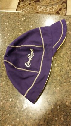 a purple hat sitting on top of a counter