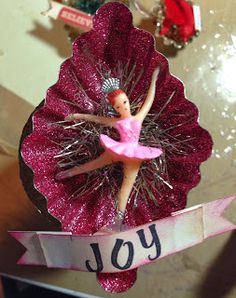 a pink ornament with a ballerina on it