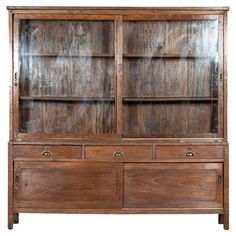 an old wooden bookcase with glass doors